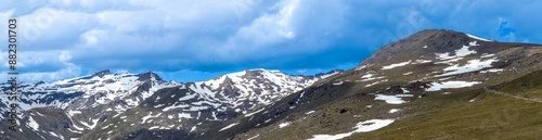 Panoramic view on snowy mountains on hiking trail to Mulhacen peak in the spring, Sierra Nevada range, Andalusia, Spain