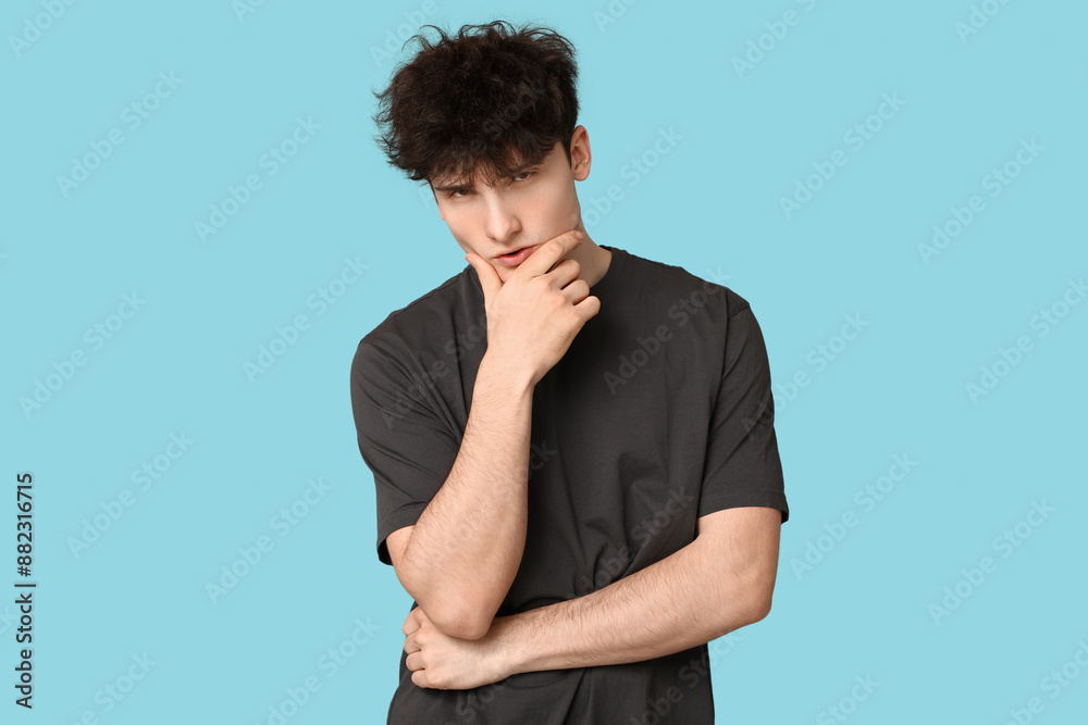 Young dark haired man on blue background Young dark haired man on blue background