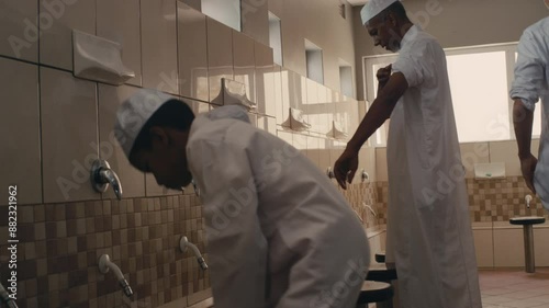 Muslim family washing itself before prayer