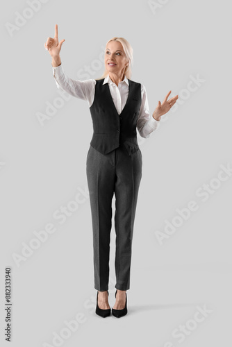 Mature businesswoman using ...