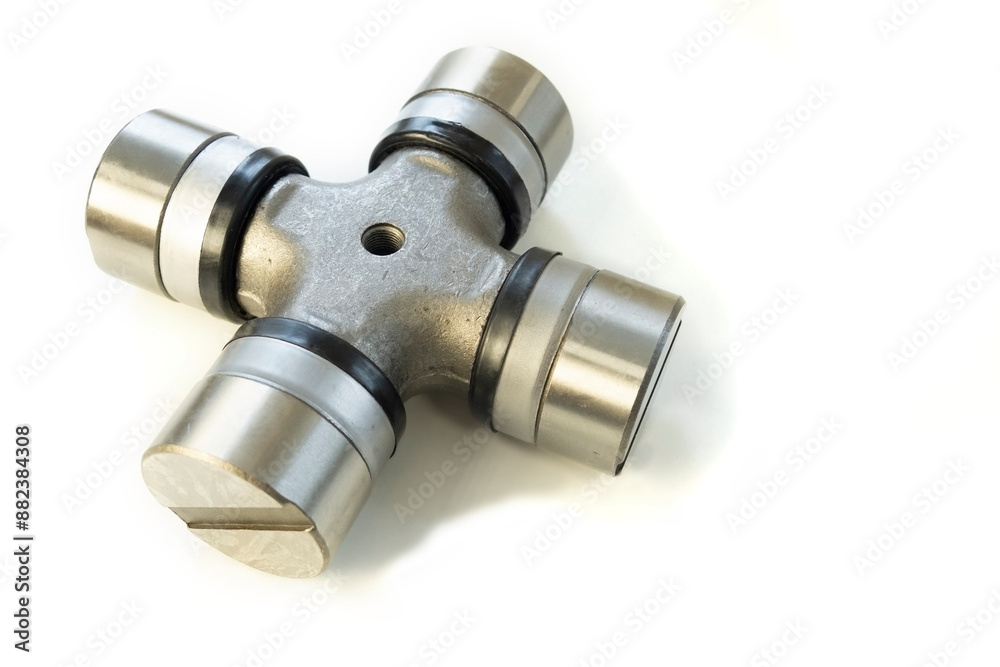 Cardan shaft crosspiece. Transmission detail on a white isolated background. Cardan shaft crosspiece. Transmission detail on a white isolated background.