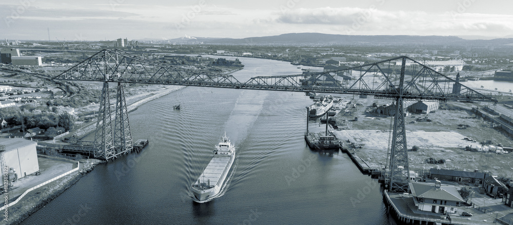 The Tees Transporter Bridge at Middlesbrough with a ship travelling up the River Tees