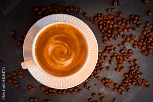 Horizontal banner with cup of coffee and coffee beans on dark stone background. Top view. Copy space - Image