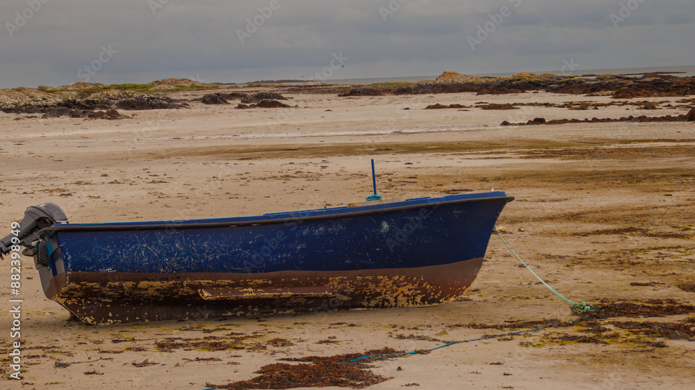 abandoned blue fishing boat on the beach in Clifden, Ireland