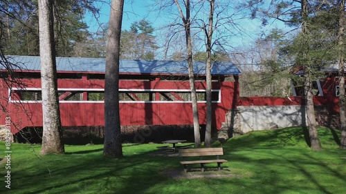 Paden covered bridges near Orangeville, PA. A pair of bridges over a stream. Wide shot travels through the trees and park to show the side of the bridges. Shot on an early Spring day. photo