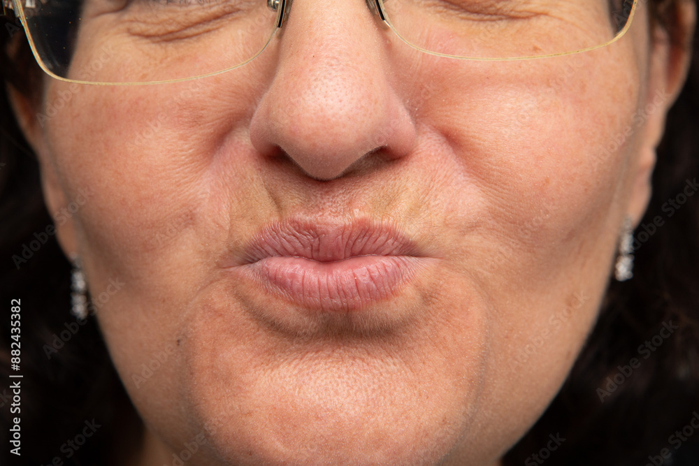Senior woman wearing glasses is making funny face Senior woman wearing glasses is making funny face