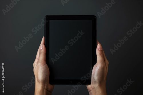 A person holds a tablet computer, a popular device for browsing and working on the go