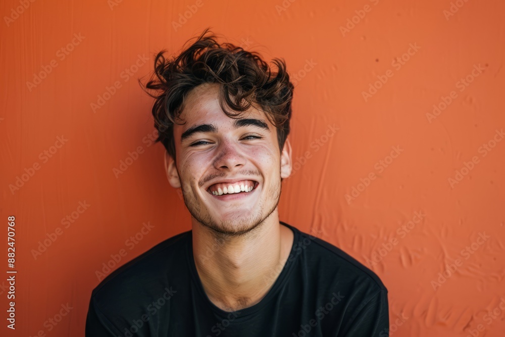 The young man has a bright smile and his image is perfect for expressing confident abstract concepts, making it a best-selling background or wallpaper The young man has a bright smile and his image is perfect for expressing confident abstract concepts, making it a best-selling background or wallpaper