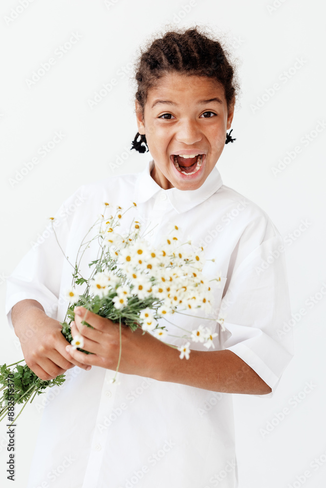 Innocent joy young boy holding vibrant daisies against a clean white backdrop Innocent joy young boy holding vibrant daisies against a clean white backdrop