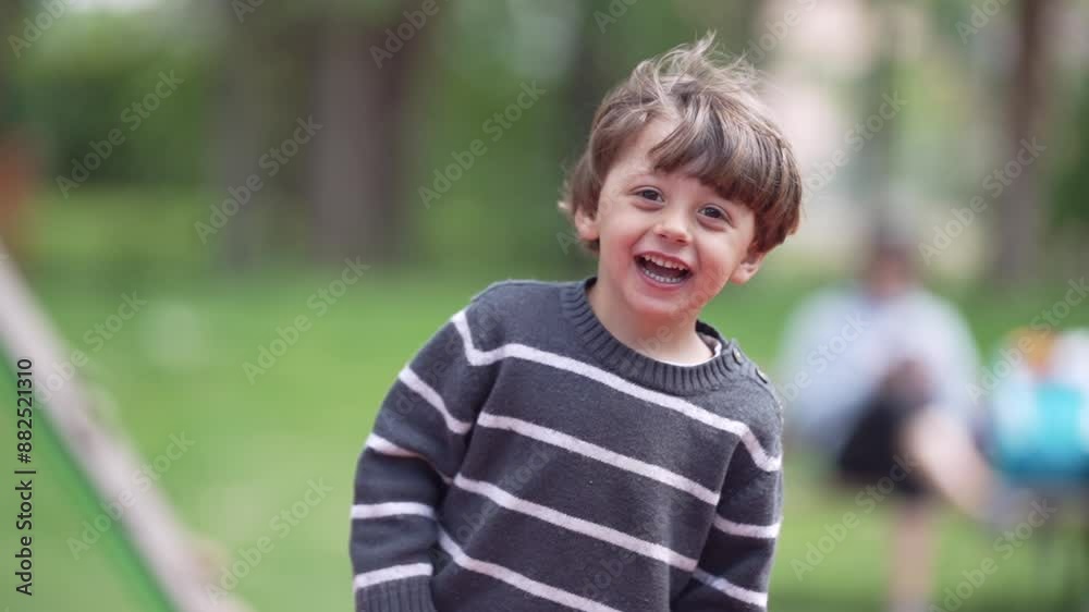 Park Fun, Smiling Boy In Striped Sweater Is In Green Area Laughing At Camera In Moment Of Extreme Joy Park Fun, Smiling Boy In Striped Sweater Is In Green Area Laughing At Camera In Moment Of Extreme Joy