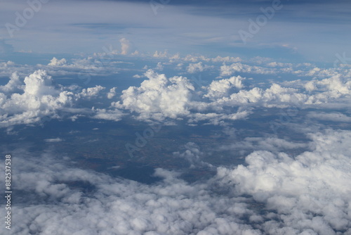 Obraz na płótnie Aerial View of Urban Landscape with Airplane Wing Under Clear Blue Sky and Scatt