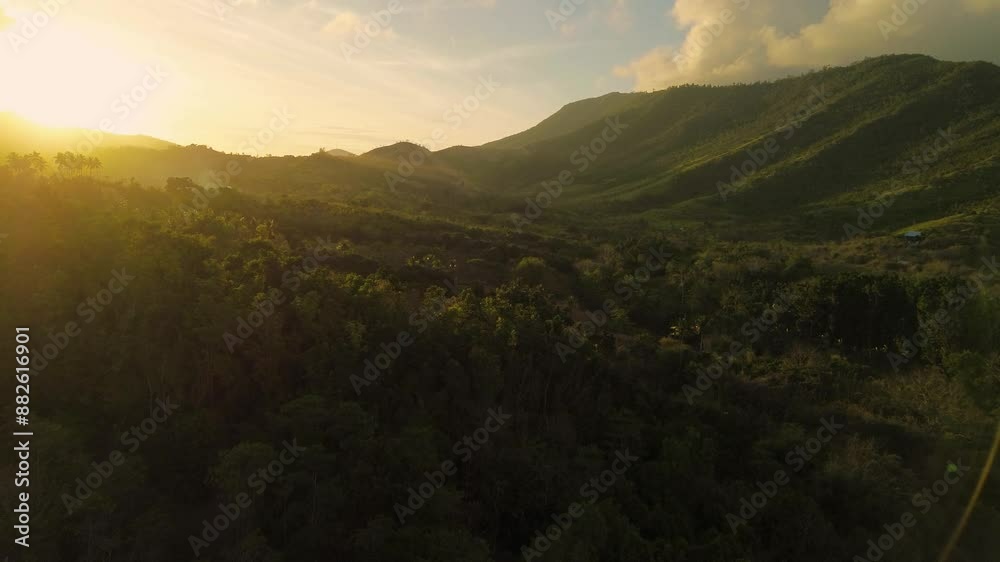 Drone footage captures the awe-inspiring sunset over Bacungan, Palawan, illuminating the landscape in warm hues. Flying between mountains, it reveals the breathtaking beauty of the landscape.