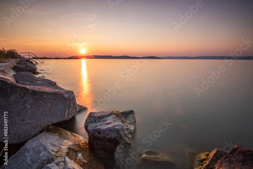 Landscape shot on the shore of a lake, nature in the sunset with a view to the horizon Siofok, Balaton, Hungary photo