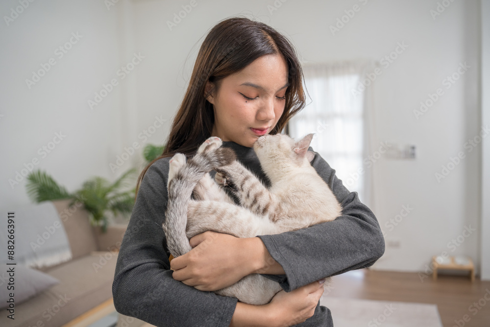 A woman reclining on a couch with her white cat resting on her legs. The setting is relaxed and comfortable A woman reclining on a couch with her white cat resting on her legs. The setting is relaxed and comfortable