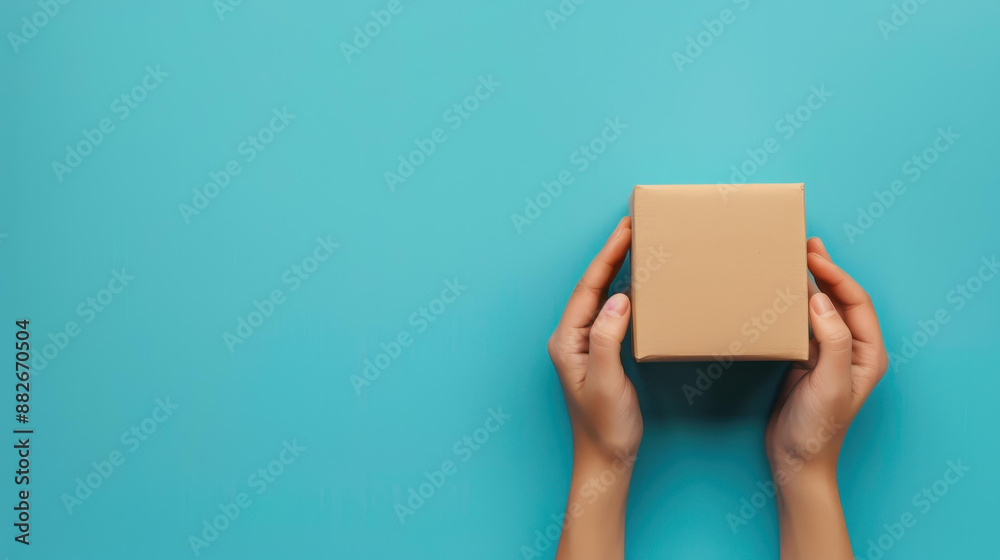 Woman hands hold brown ecological package box on blue background. Packaging concept. Woman hands hold brown ecological package box on blue background. Packaging concept.
