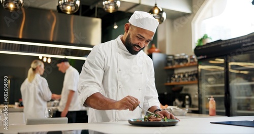 Man, chef and happy with food in kitchen at restaurant for fine dining, meal and creativity. Male employee, professional and cooker with smile for culinarily, hospitality and catering service photo