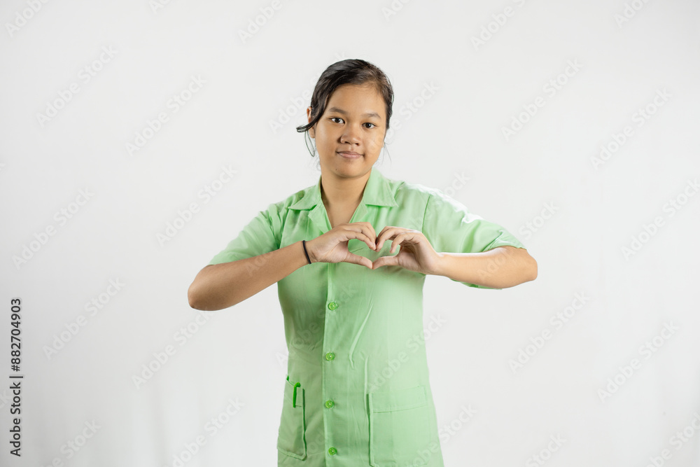 Young Asian female nurse making love shapes with her hands, gesture of love, dedicated work, concept of health care, isolated white background.
Young Asian female nurse making love shapes with her hands, gesture of love, dedicated work, concept of health care, isolated white background.