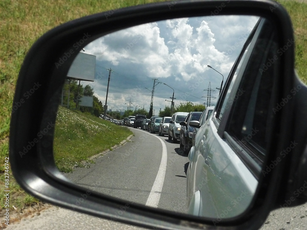 Reflection of a traffic jam in the side view mirror of the car Reflection of a traffic jam in the side view mirror of the car