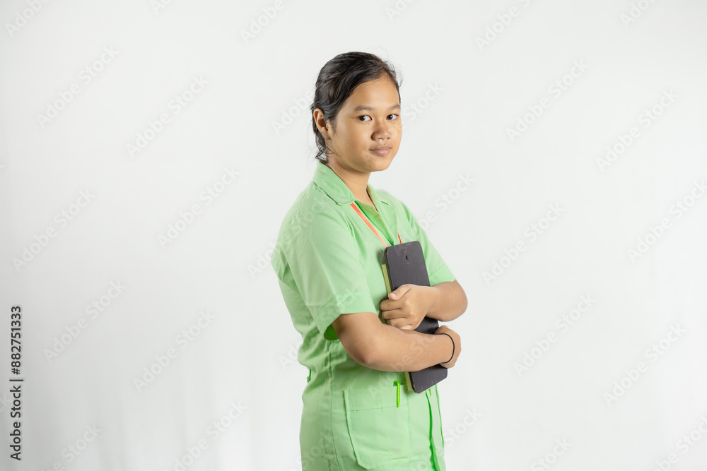 A young Asian female nurse stands confidently with a clipboard, the concept of medical treatment, dedicated and wholehearted work, isolated on a white background.
A young Asian female nurse stands confidently with a clipboard, the concept of medical treatment, dedicated and wholehearted work, isolated on a white background.
