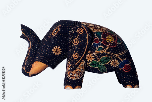 Wall decoration is made of wood, shaped like an elephant, and is painted with batik motif, isolated on white background photo