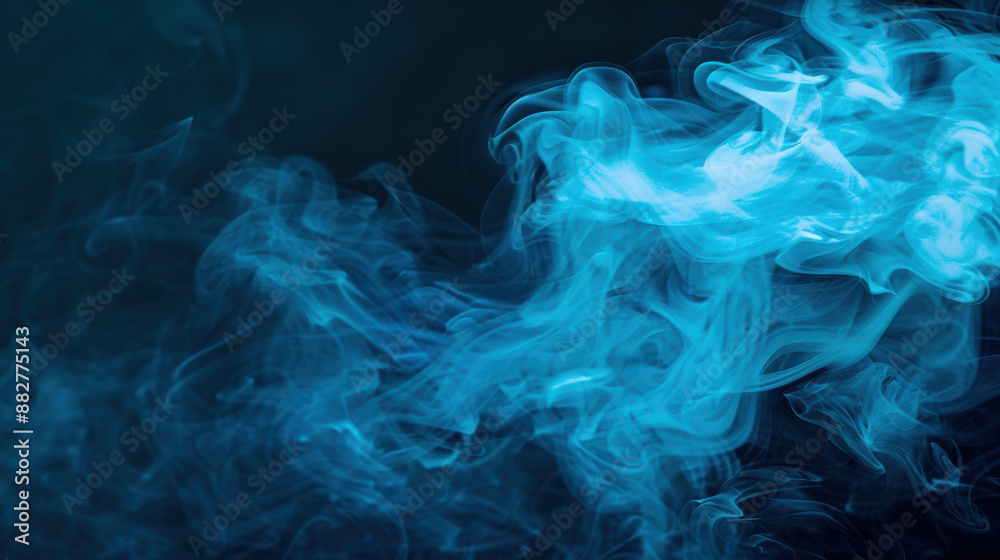 Fototapeta premium Mystical abstract blue smoke against dark background, creating an ethereal and mesmerizing atmosphere for creative art and design projects.