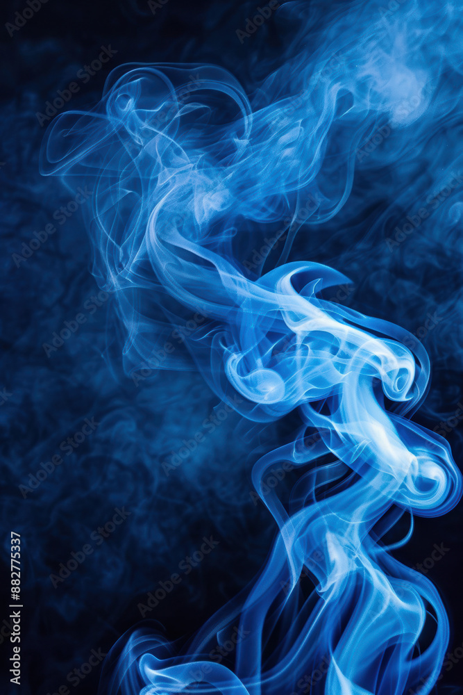 Fototapeta premium Vibrant blue smoke swirling in dark background, creating a dreamy and ethereal effect. Ideal for abstract concepts and creative design projects.