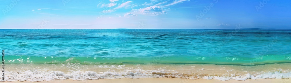 Fototapeta premium Gentle waves lapping at a pristine beach under a bright blue sky