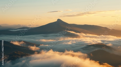 Mountain peak sunset cloudscape. Scenic view of a mountain peak with clouds at sunset.