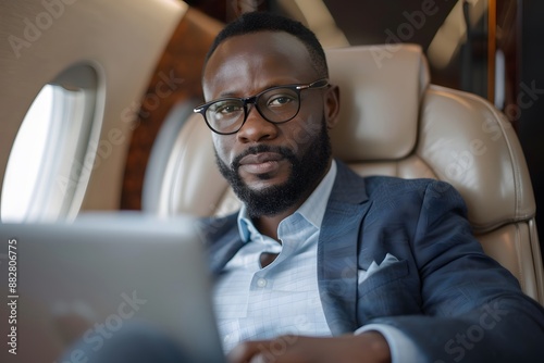 Businessman Working on a Laptop in a Private Jet