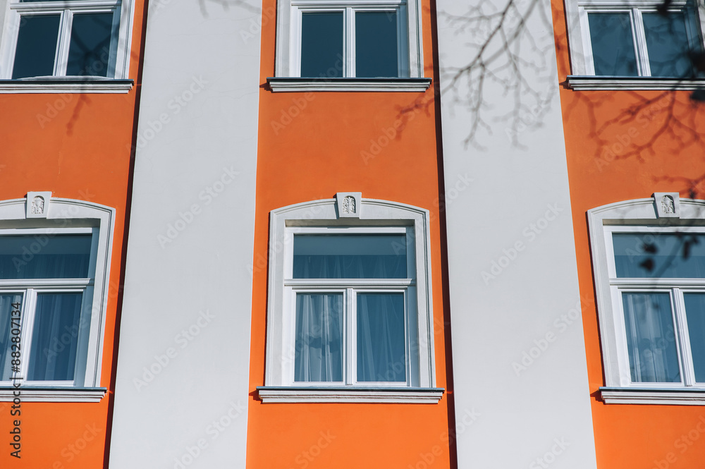 Obraz premium Old decorative architecture in Lviv, Ukraine. Windows on the red facade of the house in the central historical part of the city.