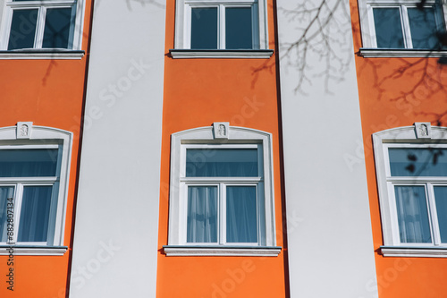 Old decorative architecture in Lviv, Ukraine. Windows on the red facade of the house in the central historical part of the city. photo