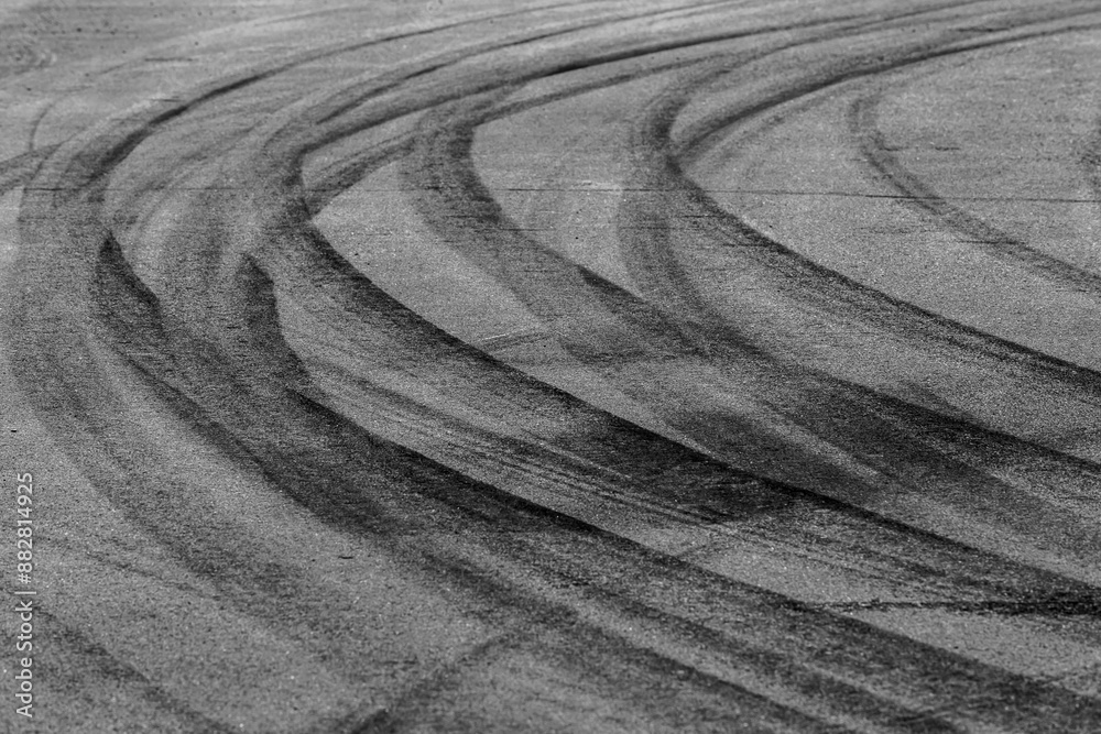 Aerial view Textured background vehicle traces on asphalt road, Tire print texture transport, Car tire mark burnout texture and background, Tire mark on the asphalt road race track.