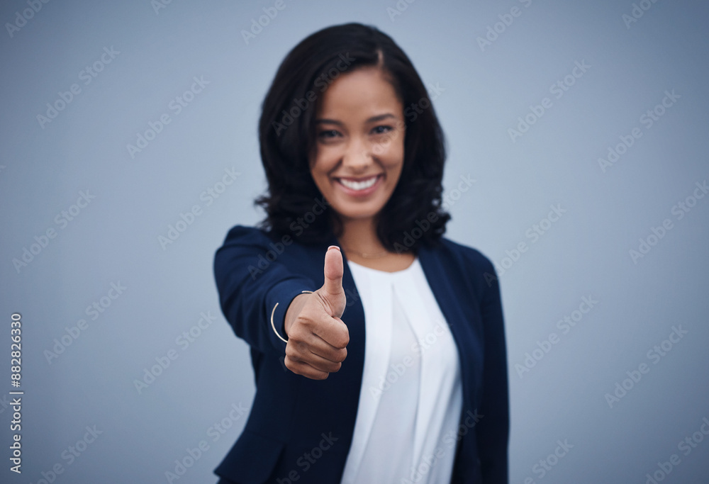 Happy woman, portrait and review with thumbs up for winning, good job or success on a blue studio background. Female person or employee with smile, like emoji or yes sign for well done or thank you Happy woman, portrait and review with thumbs up for winning, good job or success on a blue studio background. Female person or employee with smile, like emoji or yes sign for well done or thank you