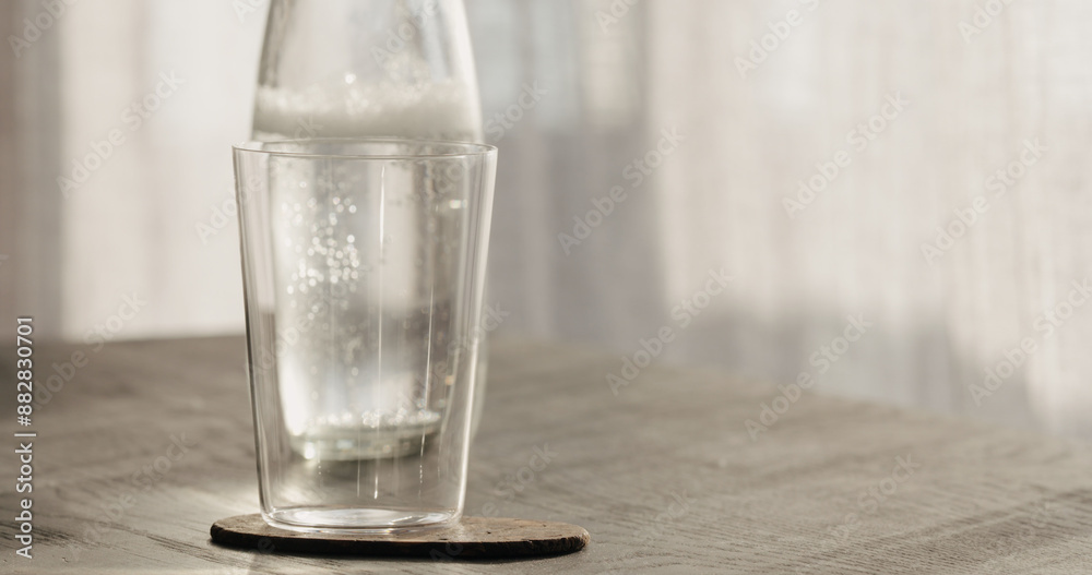 tumbler glass with bottle on black oak table