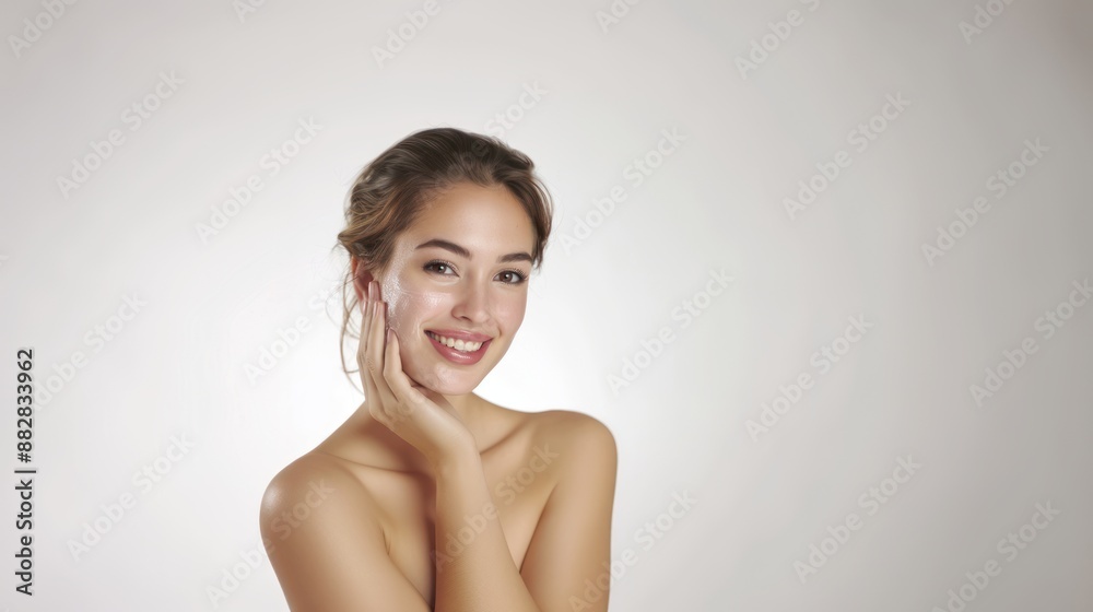 An American woman with clean and healthy skin is smiling and touching her face on a white background skincare concept An American woman with clean and healthy skin is smiling and touching her face on a white background skincare concept