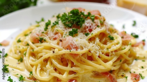 A delicious plate of spaghetti carbonara, topped with crispy pancetta, a rich creamy sauce, and freshly grated Parmesan cheese.