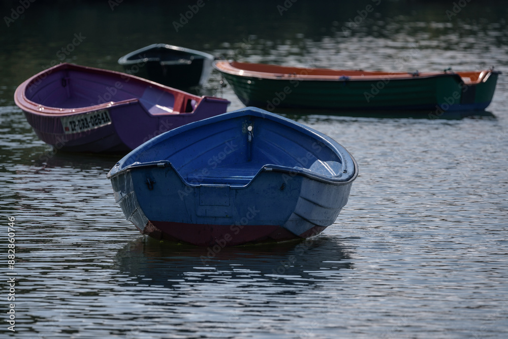 Naklejka premium LANDSCAPE BY THE LAKE - Small old rowing boats on the lake 