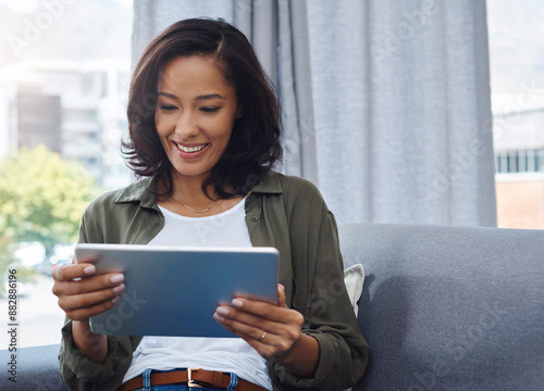 Woman, house and happy with tablet for online or digital application for house finance. Female person, living room and smile on email with good news or communication for loan and mortgage approval