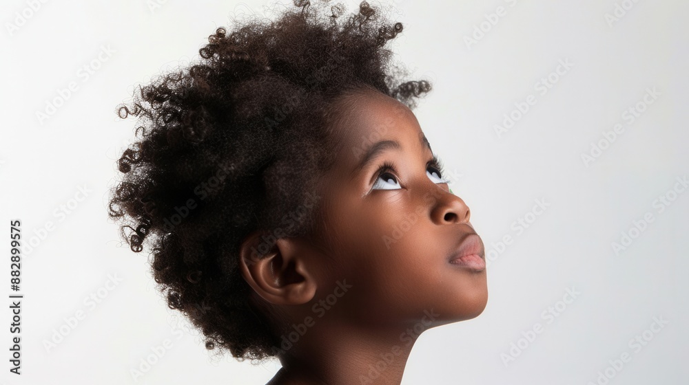 Thoughtful black child looking up, isolated on a clean white background Thoughtful black child looking up, isolated on a clean white background