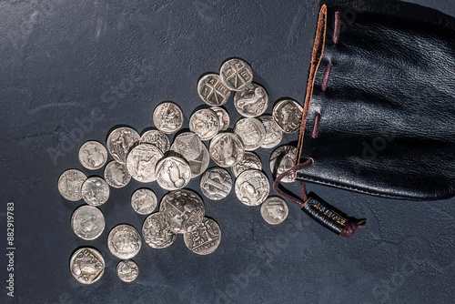Leather pouch full of ancient silver coins