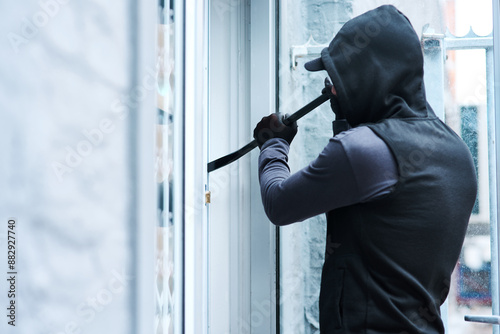 Man, criminal and crowbar for house crime, home invasion and breaking entering attempt with tool. Apartment, robbery and burglary or trespassing on property, security breach and owners safety risk photo