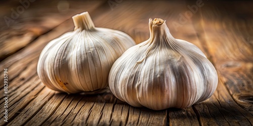 Close-up of two plump garlic cloves with dry skin on rustic wooden table, garlic, cloves, close-up, food, organic, ingredient