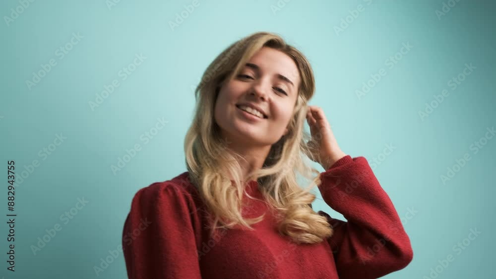 Happy young woman in maroon pullover flaunting long hair Happy young woman in maroon pullover flaunting long hair