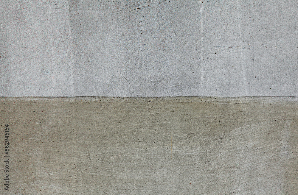 Fototapeta premium Grey wall, texture, background. Gray multi-layered wall covering. Rough, uneven surface. Cement plaster on a brick wall. Concrete poured surface with traces of smearing. Grey surface and backdrop