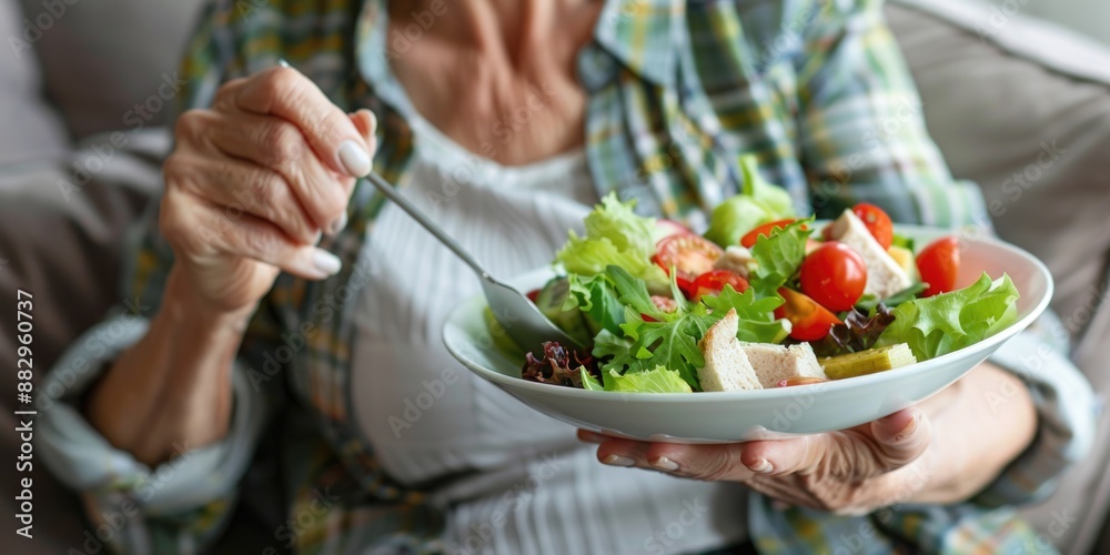 A person holding a bowl of mixed greens and vegetables, ideal for food or lifestyle photography A person holding a bowl of mixed greens and vegetables, ideal for food or lifestyle photography