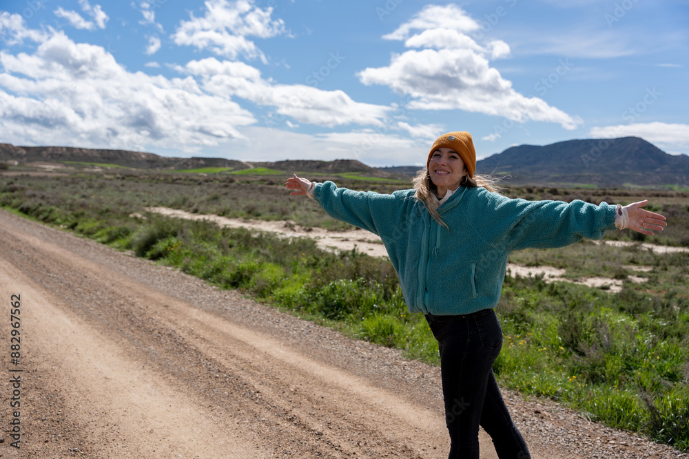 Woman shows herself smiling and happy with open arms on the road Woman shows herself smiling and happy with open arms on the road