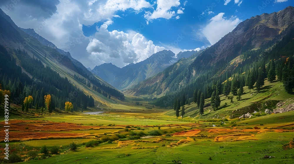 Fototapeta premium Majestic view of beautiful lush green valley with trees and colorful grass against picturesque high mountains. 