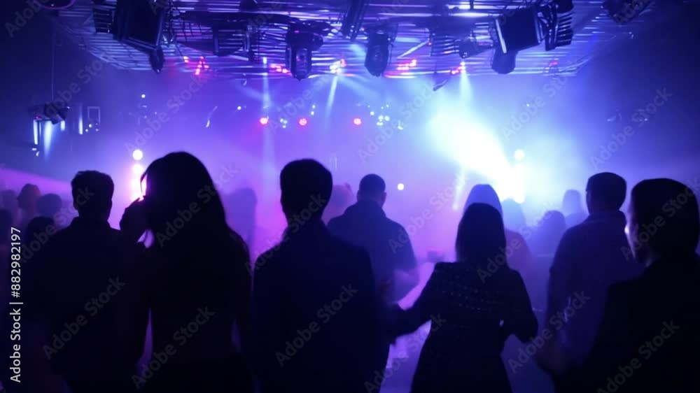 Silhouette, party or crowd in a underground club, dance concert dancing with freedom in crazy rock music festival at night. Audience, nightclub and excited people at a techno, rave or punk disco event Silhouette, party or crowd in a underground club, dance concert dancing with freedom in crazy rock music festival at night. Audience, nightclub and excited people at a techno, rave or punk disco event