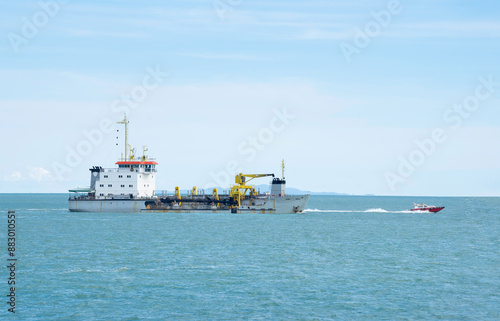 Dredgers are exploring the sea near the coast.