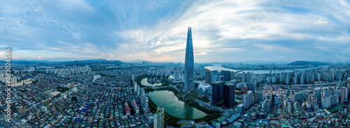 Jam-sil, Songpa-gu, Seoul, South Korea - August 20, 2023: Panoramic and afternoon view of villas and apartments with Lotte World Tower and Seokchon Lake against Han River
 photo